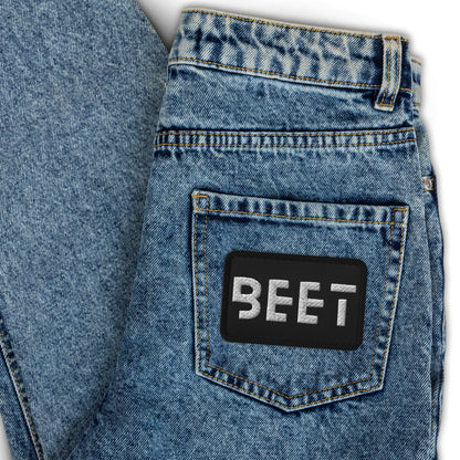 Black patch featuring the BEET logo.