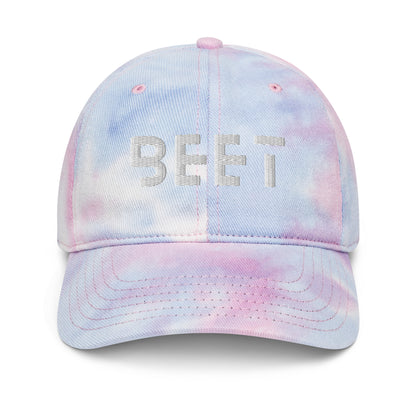 BEET tie dye baseball cap featuring vibrant, multi-colored patterns with the BEET logo on the front.